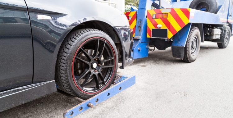 tow-truck-towing-a-broken-down-car-on-the-street-P46CHJA tow-truck-towing-a-broken-down-car-on-the-street-P46CHJA